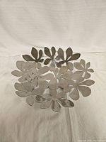 Top-down view showing the full floral pattern and circular shape of the metal bowl.