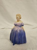 Front view of the Royal Doulton Marie figurine showing detailed facial features and gradient dress.