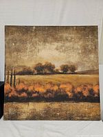 Full view of the wrapped canvas print showing a tree and field scene in warm autumn colors.
