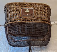 View of front wicker weave and metal mesh bottom with mounting hardware plate.