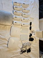 Wide layout showing two Ajax hubs, HomeSiren, multiple MotionProtect detectors and two slender sensors