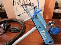 Blue Tacx Blue Twist bike trainer with magnetic brake and resistance adjustment knob, visible frame and flywheel