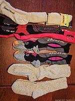 Photo showing all six pairs of technical ski and hiking socks laid out on a wooden surface.