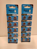 Two blister packs containing 10 AG13 / LR44 alkaline button cell batteries each, showing front of packaging with battery details and quantity.