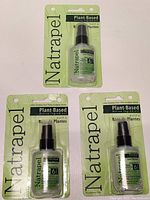 Three Natrapel plant-based insect repellent spray bottles in original packaging showing front view of package, clear plastic spray bottle with green label inside blister pack card.