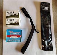 Photo showing straight razor, two boxes of Astra blades and one box of Crown blades on a light background.