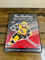Front cover of the Tim Hortons NHL Trading Cards binder, featuring an NHL player in yellow and black uniform.
