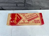 Closed original cardboard box with red and beige print, showing the V-Master branding and instructions.