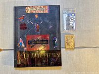 Black Harry Potter binder with various themed stickers and a gold toned Nintendo Pokemon bar.