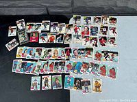 Wide shot of multiple vintage O-Pee-Chee NHL hockey cards laid out, includes various teams and players, mostly 1970s era cards.