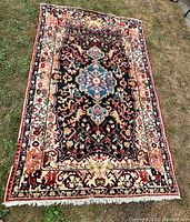 Full view of rug laid flat on grass