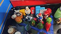 Variety of assorted dinner themed and novelty salt and pepper shakers in different shapes and colors including chef, avocado, pepper, stove, fridge, airplanes.