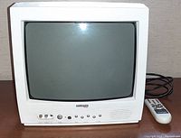 Front and side view of white Diamond Vision CRT television showing screen, control buttons, input RCA jacks, and speaker grille.