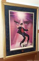 Framed art piece showing Elvis Presley dancing 'Jailhouse Rock' with a highlighted background and embedded gold coin.
