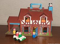Fisher-Price vintage house playset with four Little People figures and a car in front.