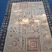 Full view of the vintage large area rug showing its overall pattern and border details.