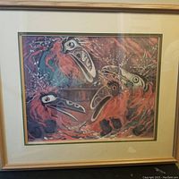 Full view of framed print showing three stylized bird-like figures with bright red-orange plumage and large beaks.