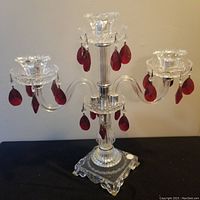 Full view of Polish crystal 3-arm candelabra with red hanging crystals on each arm, showing overall structure and detail.