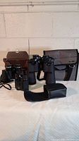 Photo showing all three binoculars along with their respective cases: a full-size Bell and Howell, a mid-size Jason, and a small Bausch & Lomb binocular.