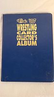 Front of blue Classic WF Wrestling Card Collector's Album with gold text