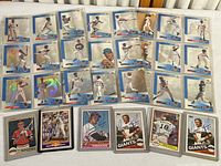 Full view of all cards in lot showing autographed cards and binder pages with holograms