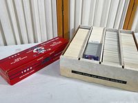 Photo of one large box labeled 1993 Fleer and Donruss Doubles with baseball cards in a white divided tray, alongside a red box showing 1988 Score Collector Set