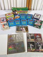 Display of thirteen boxes and albums of baseball card collections including partial and unopened sets, Donruss card, and two small ringed albums with cards in plastic sleeves.