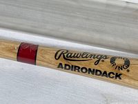 Close-up image of the wooden baseball bat barrel showing Rawlings branding and Adirondack Pro Ring text.