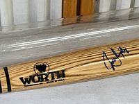 Close-up of Worth logo, model number WC117, and player autograph on the bat.