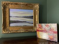 Painting and book displayed together on table