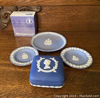 All four Wedgwood items including three plates and a trinket box, with original box for the trinket box