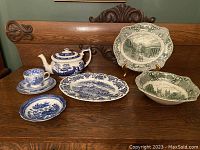 Photo of all listed dishes and teapot showing full set arrangement on wooden surface.