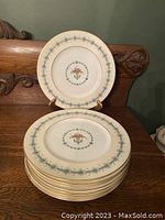 Stack of 9 matching Coalport Queen Elizabeth menu/dinner plates with a central fruit basket motif and blue floral border.