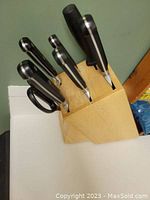 Front angle of the wooden block holding the knives and scissors