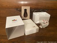 Original box with Canada 150 branding, inner cardboard sleeve, and ceramic polar bear figurine decorated in indigenous art style.