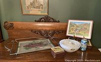 Overview of all items on wooden surface including metal tray with grape design, wooden tray with rural landscape, coasters stacked, three white glass bowls, and a soda can for size reference.