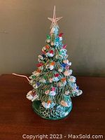 Front view of the ceramic Christmas tree with colored bulbs.