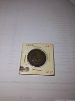 Photo of the 1852 Quebec half penny coin in a paper flip holder labeled '1852 1/2' and '#17'.