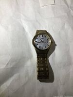 Full view of Citizen Eco-Drive men's solar watch with metal band lying flat on a white surface.