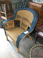 Image of plastic wicker chair showing front and side view in storage setting