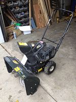 Full view of snowblower showing auger housing, engine and handle