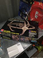 Original boxed Star Trek Deep Space Nine model kit with fiber optic lighting system shown on a metal surface.