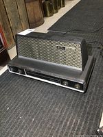 Front view of vintage Arvin FM Stereo amplifier showing the control panel with knobs and tuning dial.