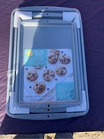 Top view of 3 Wilton Recipe Right baking sheets stacked with original labels, silver colored, new