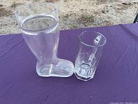 Set on outdoor table with purple cloth, showing full boot and stein shape and size comparison.