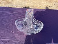 Front angle view showing the basket's design, handle, and the intricate cut glass patterns.