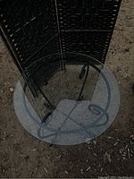 Top view of the circular glass table top showing the wrought iron base underneath.