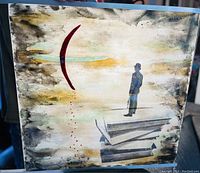 Front view of the glass painting showing the silhouetted figure on abstract book shapes with red crescent and dots.