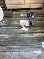 Top view of the glass coffee table showing its transparency, rectangular shape, and some items on top.