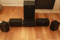 Front view of all six speakers and subwoofer arranged on floor